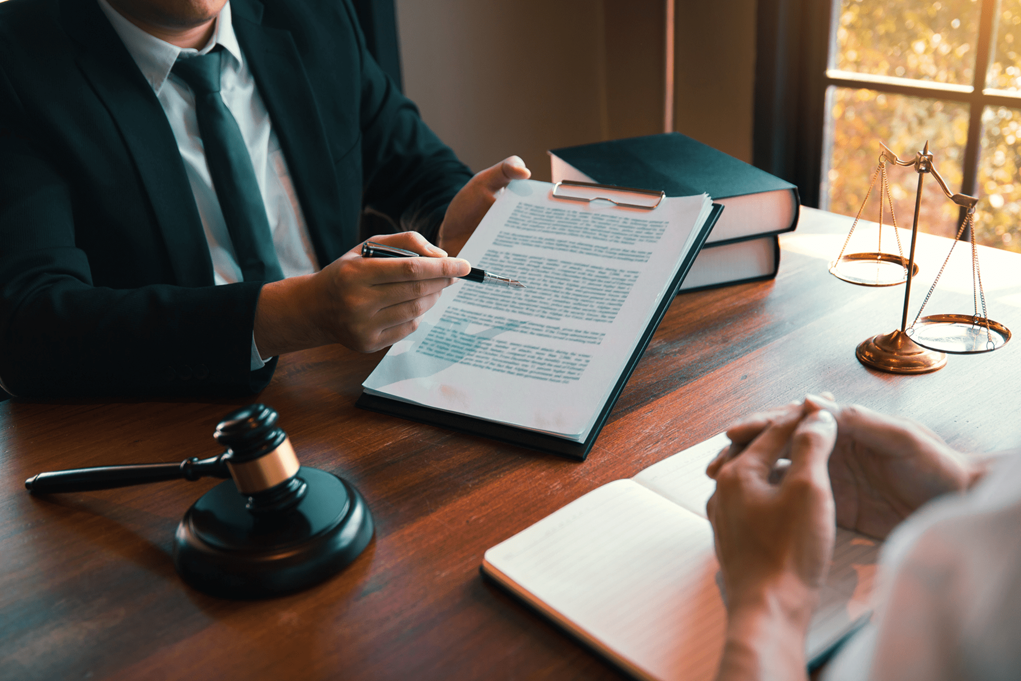 Lawyers discussing legal document at a desk.